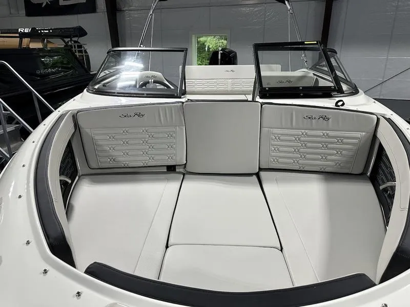 Slide: The Image of 2025 Sea Ray SPX 210 OB boat interior with white seating and sleek design. - 6