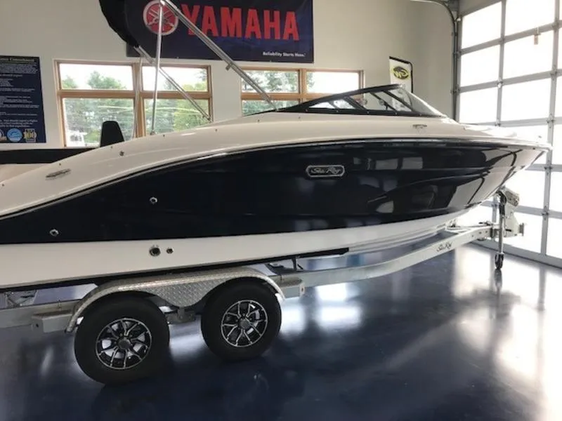 The Image of 2025 Sea Ray SPX 210 OB boat on trailer in showroom. - 1