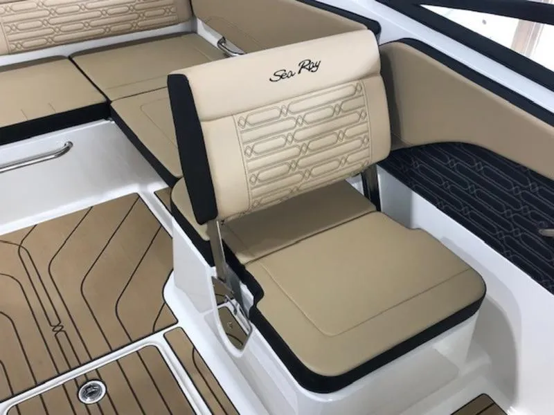 Slide: The Image of 2025 Sea Ray SPX 210 OB boat interior with beige seating and stylish design. - 12