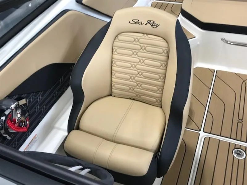 Slide: The Image of 2025 Sea Ray SPX 210 OB boat interior with beige and black seating. - 13