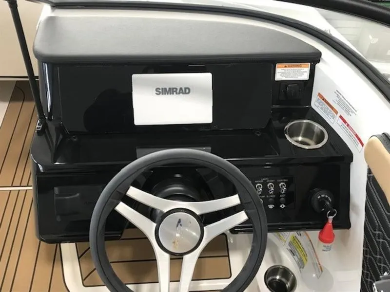 Slide: The Image of 2025 Sea Ray SPX 210 OB dashboard with Simrad display and steering wheel. - 14