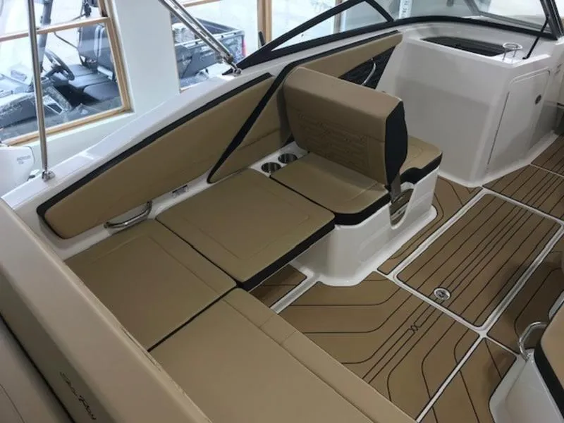 Slide: The Image of 2025 Sea Ray SPX 210 OB boat interior with tan seating and sleek design. - 7