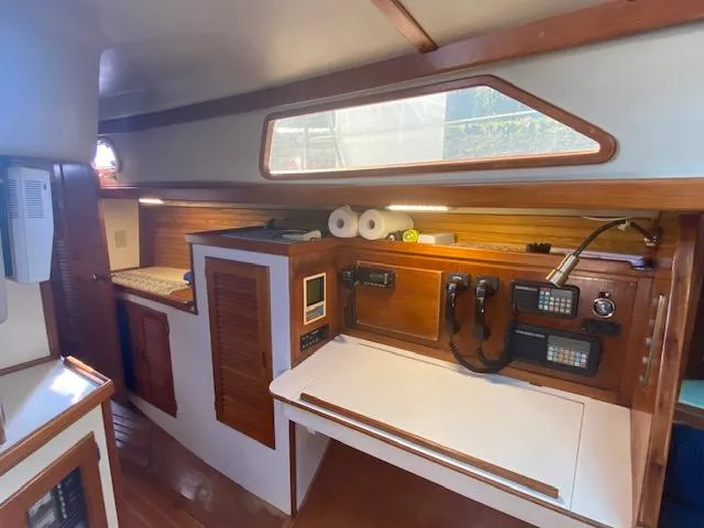 Slide: The Image of 1989 Morgan 44 Center Cockpit interior with navigation station and wooden cabinetry. - 7