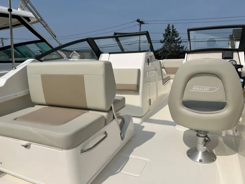 Slide: The Image of 2025 Boston Whaler 210 Vantage boat interior with beige seating and modern design. - 5