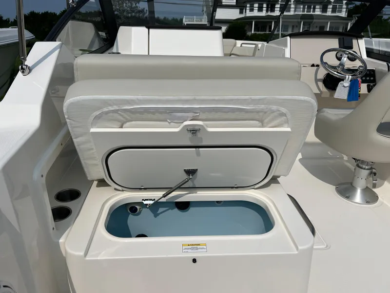 Slide: The Image of 2025 Boston Whaler 210 Vantage boat interior with open storage compartment. - 7