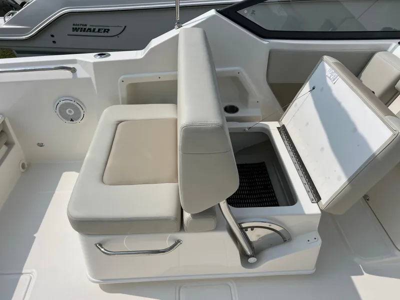 Slide: The Image of 2025 Boston Whaler 210 Vantage boat seat with storage compartment open. - 9