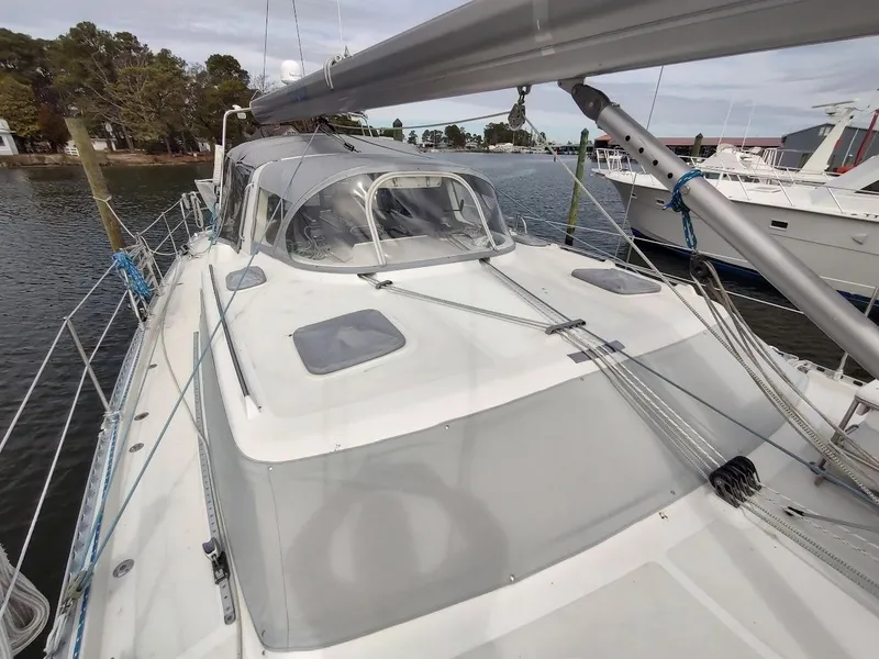 Slide: The Image of 2005 Stevens Custom 53/56 sailboat docked, featuring a sleek deck and rigging. - 13