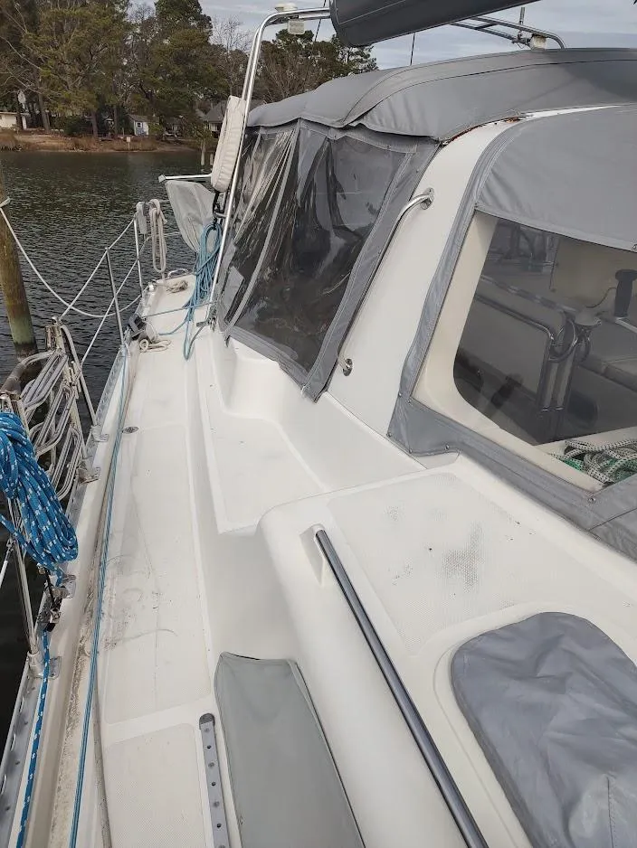 Slide: The Image of 2005 Stevens Custom 53/56 sailboat docked, featuring a covered cockpit and sleek deck design. - 20