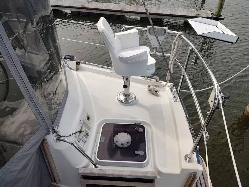 Slide: The Image of 2005 Stevens Custom 53/56 yacht deck with white captain's chair and railing. - 22