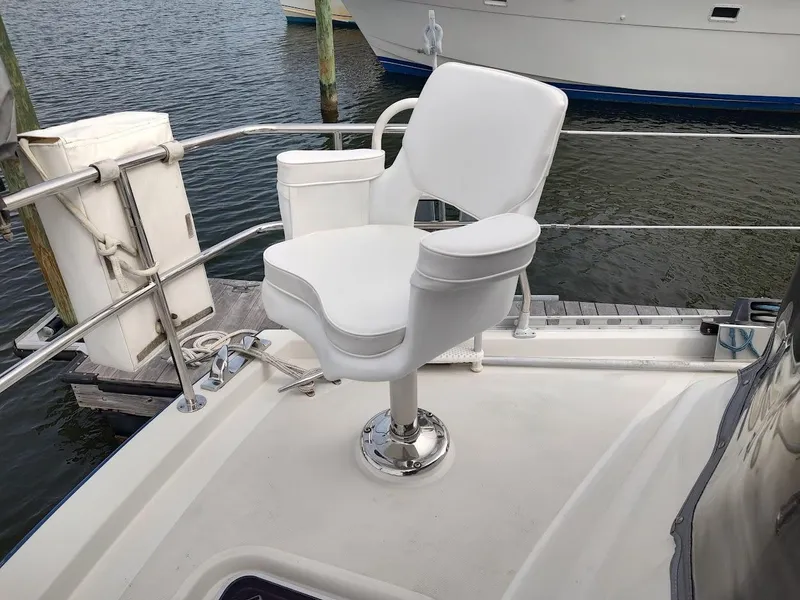 Slide: The Image of White captain's chair on a Stevens Custom 53/56 yacht, docked by the water. - 23