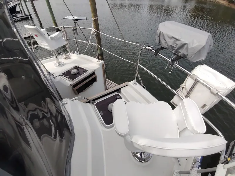 Slide: The Image of Stevens Custom 53/56 yacht deck with white seating, docked by the water. - 26