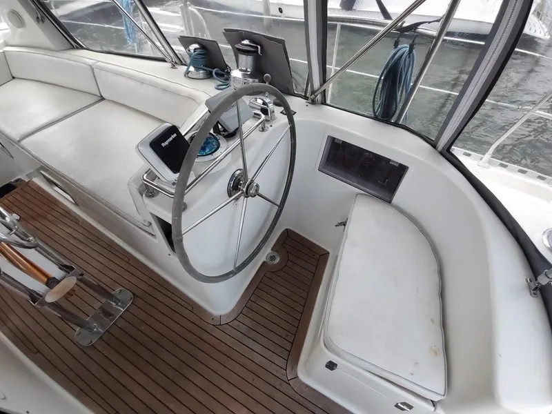 Slide: The Image of Stevens Custom 53/56 yacht cockpit with steering wheel, wooden flooring, and seating, 2005 model. - 29