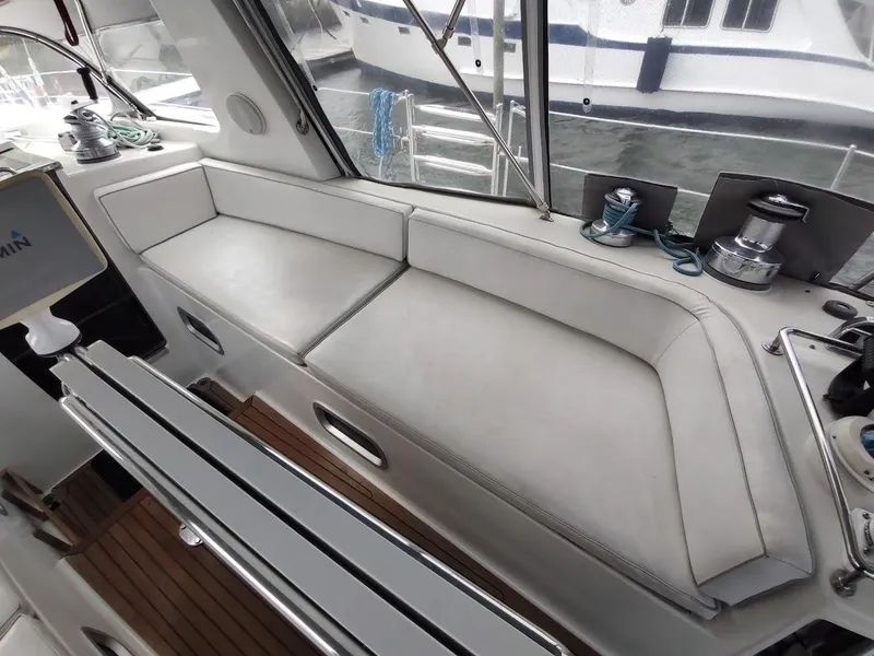 Slide: The Image of Luxurious seating area on a 2005 Stevens Custom 53/56 yacht, featuring white cushions and nautical equipment. - 31