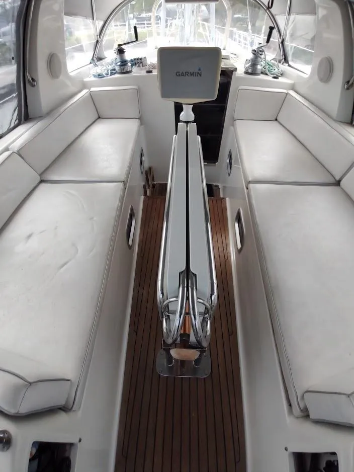 Slide: The Image of Interior of 2005 Stevens Custom 53/56 yacht with white seating and Garmin equipment. - 32