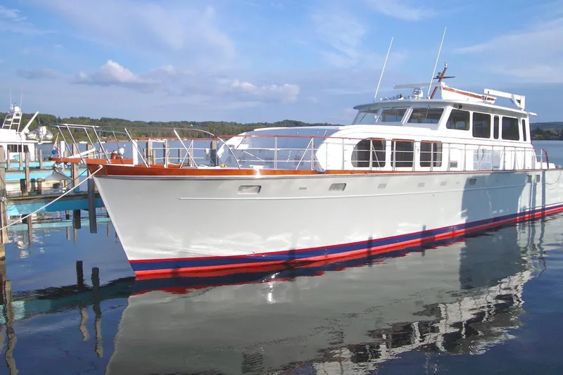 Slide: The Image of 1970 Huckins Offshore yacht docked at a marina. - 0