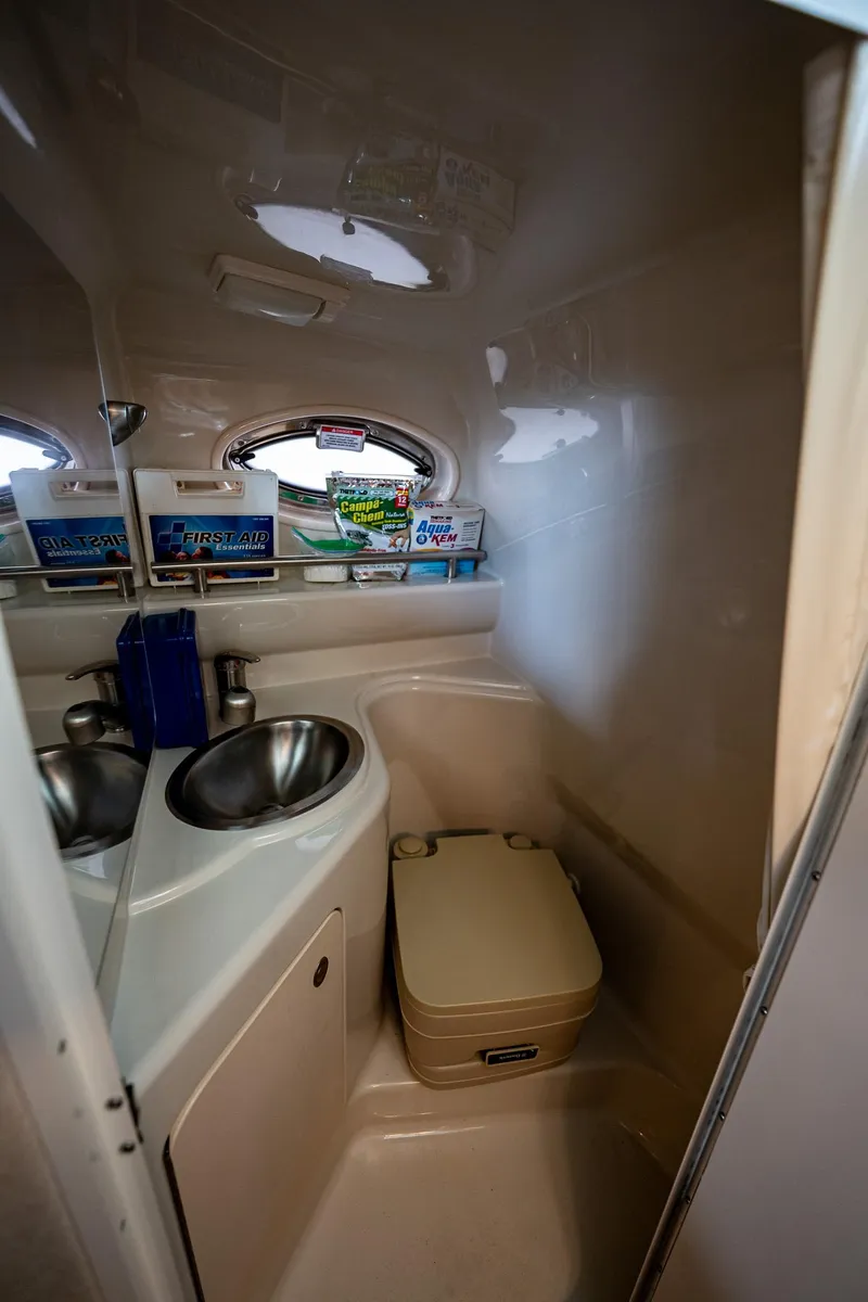 Slide: The Image of Compact bathroom in 2008 Sea Ray 240 Sundancer boat with sink and toilet. - 11
