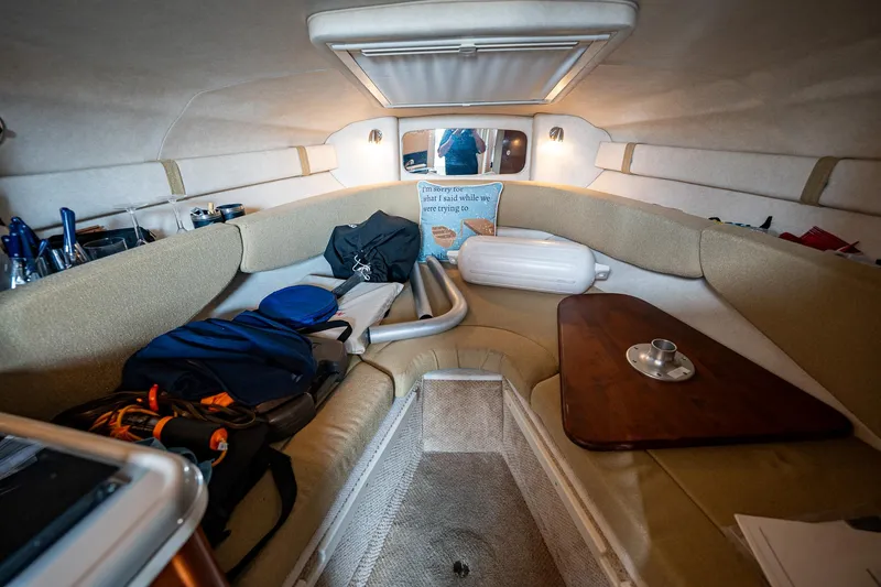 Slide: The Image of Interior cabin of a 2008 Sea Ray 240 Sundancer boat with seating and storage. - 13