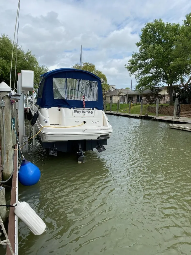 Slide: The Image of 2008 Sea Ray 240 Sundancer docked in a calm marina. - 17