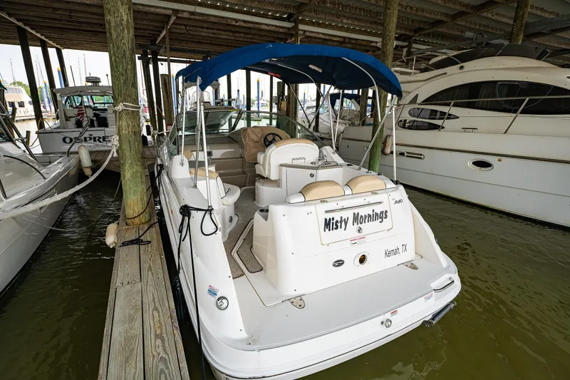 Slide: The Image of 2008 Sea Ray 240 Sundancer docked, named Misty Mornings, with blue canopy. - 4