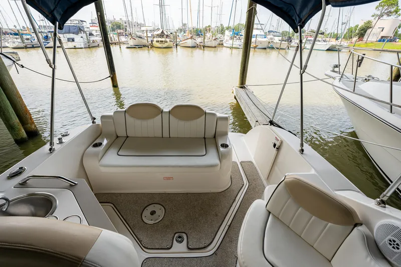Slide: The Image of 2008 Sea Ray 240 Sundancer boat interior with seating and marina view. - 5