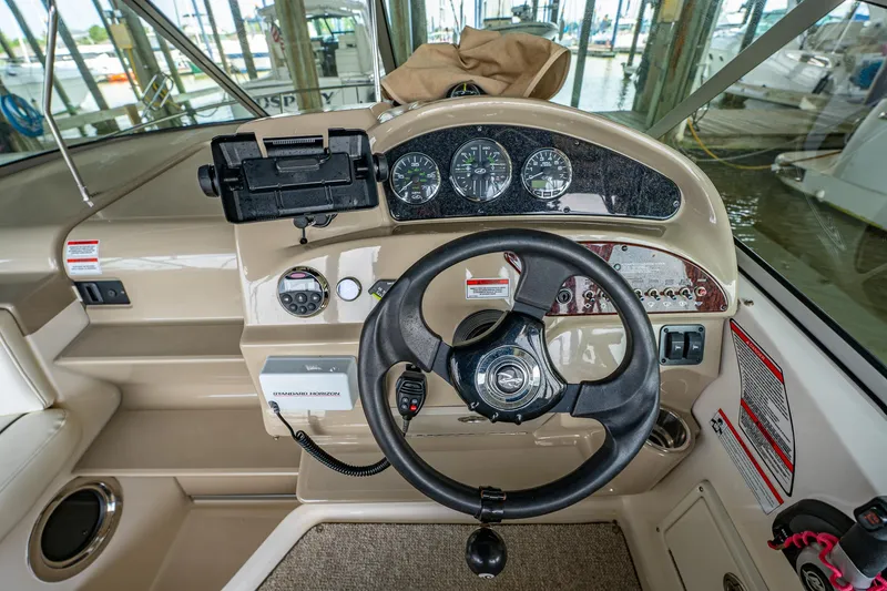 Slide: The Image of 2008 Sea Ray 240 Sundancer helm with steering wheel and instrument panel. - 8