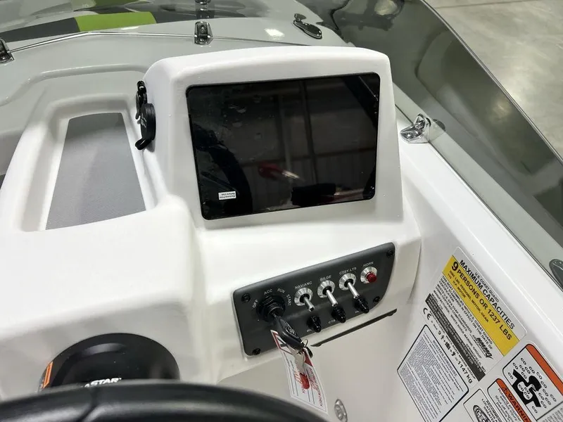 Slide: The Image of 2024 Tahoe T18 boat dashboard with control panel and display screen. - 10