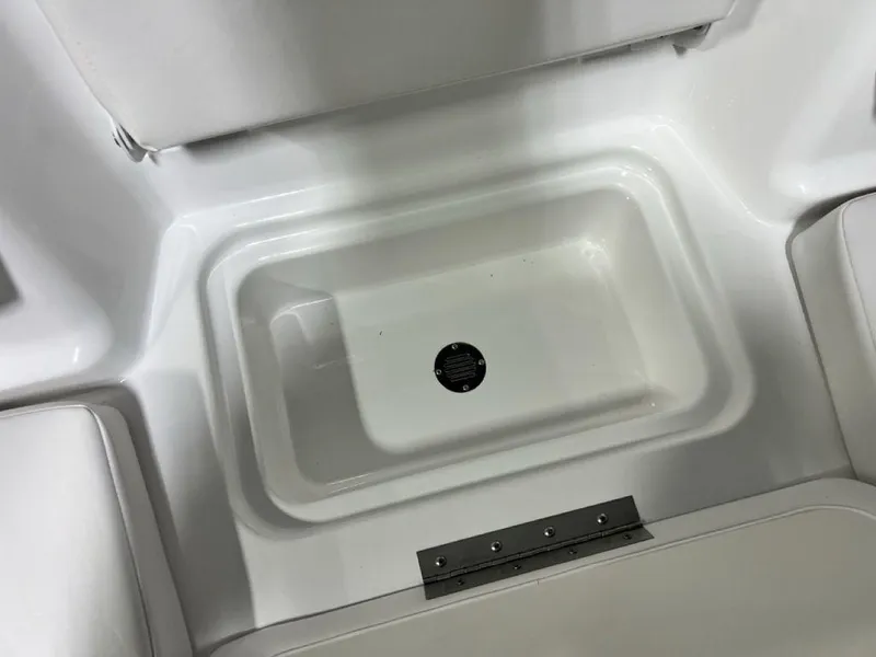 Slide: The Image of 2024 Tahoe T18 boat storage compartment with white interior. - 14