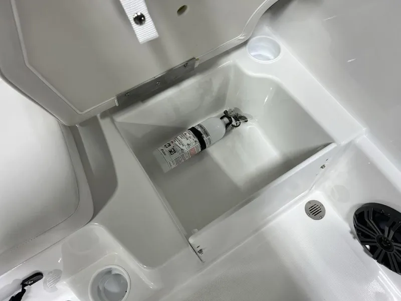 Slide: The Image of 2024 Tahoe T18 boat storage compartment with fire extinguisher. - 15