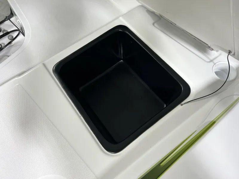 Slide: The Image of 2024 Tahoe T18 boat storage compartment with open lid. - 18