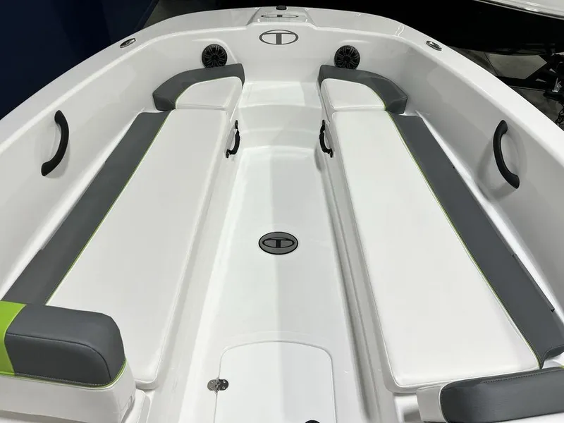 Slide: The Image of 2024 Tahoe T18 boat interior with white and gray seating, green accents, and built-in speakers. - 4
