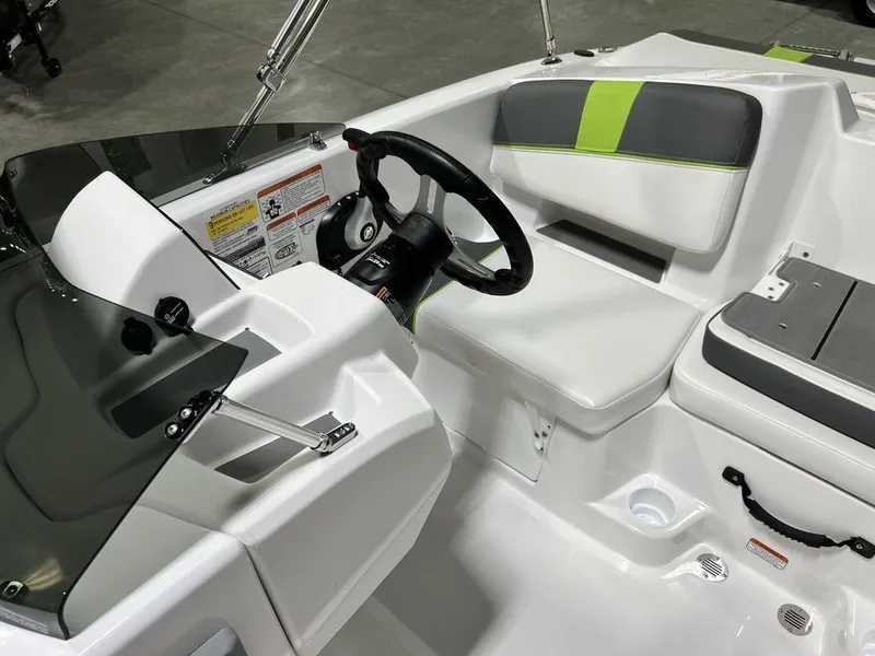 Slide: The Image of 2024 Tahoe T18 boat interior with steering wheel and seating area. - 9