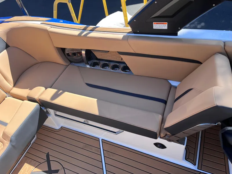 Slide: The Image of 2024 MasterCraft X24 boat interior with tan leather seating and teak flooring. - 10