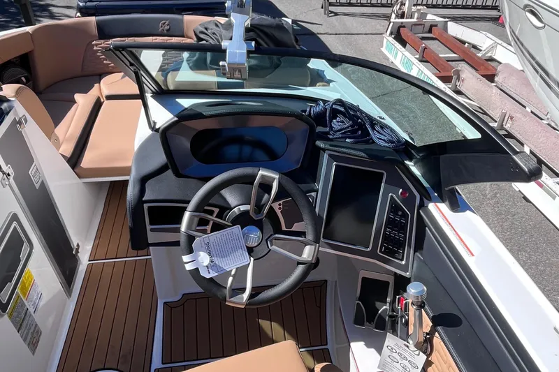 Slide: The Image of 2024 MasterCraft X24 boat interior with steering wheel and dashboard. - 12