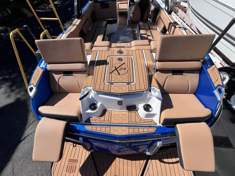 Slide: The Image of 2024 MasterCraft X24 boat with luxurious seating and teak flooring. - 7