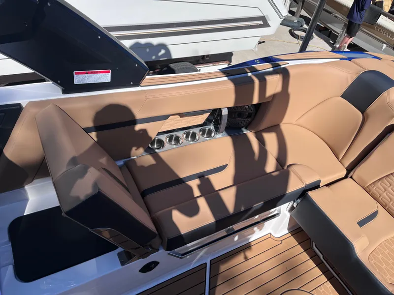 Slide: The Image of 2024 MasterCraft X24 boat interior with tan leather seating and wood flooring. - 9