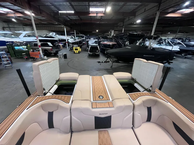 Slide: The Image of 2024 MasterCraft XT23 boat interior in a showroom with other boats. - 15