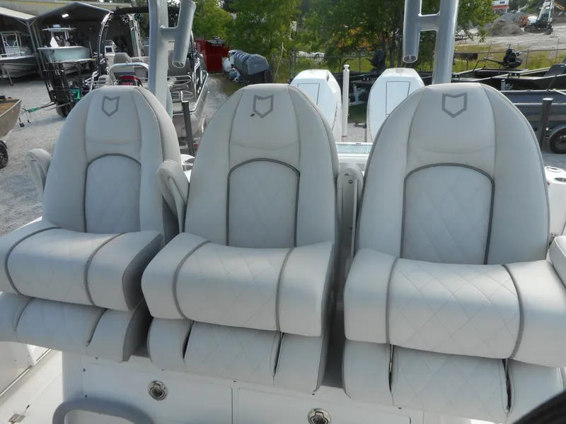 Slide: The Image of 2024 Sea Fox 328 Commander boat with three luxurious, white, diamond-stitched seats. - 11