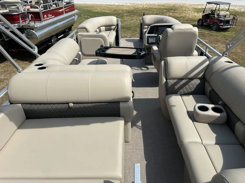 Slide: The Image of 2024 Sun Tracker Party Barge 22 RF DLX interior with plush seating and cup holders. - 15