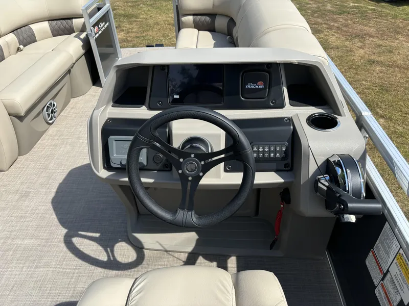 Slide: The Image of 2024 Sun Tracker Party Barge 22 RF DLX helm with steering wheel and controls. - 16
