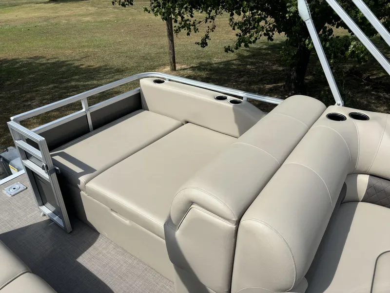 Slide: The Image of 2024 Sun Tracker Party Barge 22 RF DLX with beige seating and cup holders. - 7