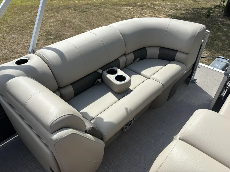Slide: The Image of 2024 Sun Tracker Party Barge 22 RF DLX with beige seating and cup holders. - 8
