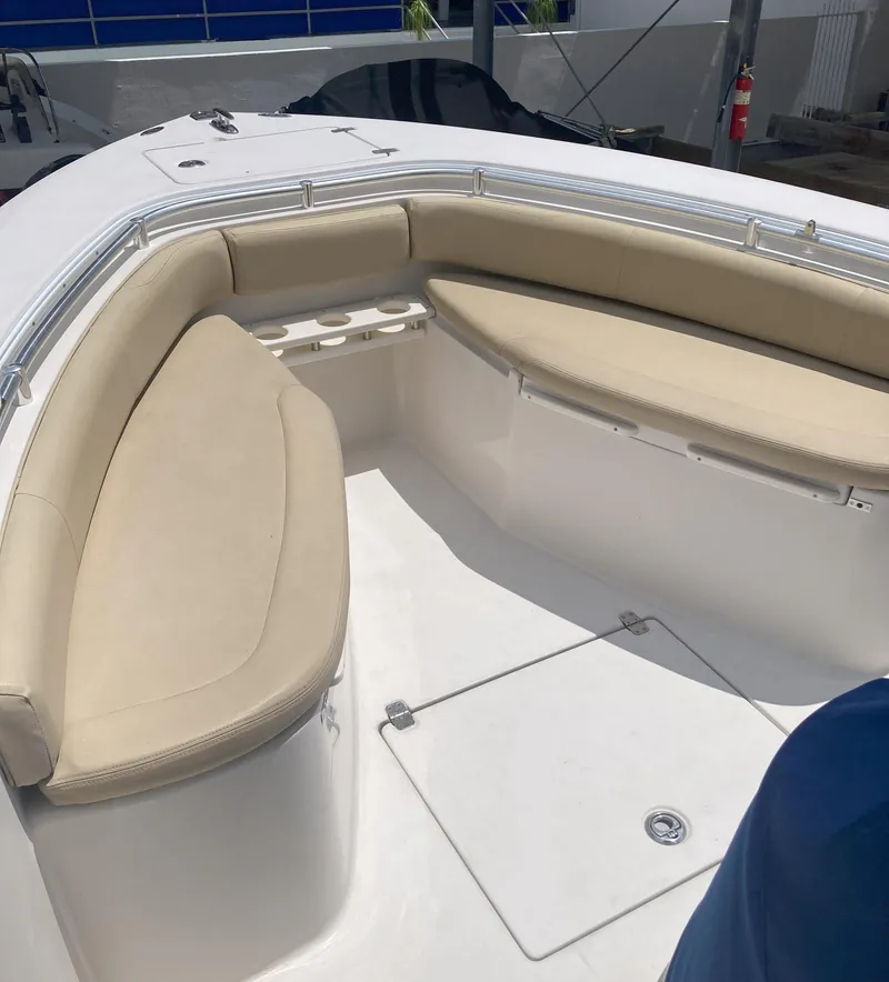 Slide: The Image of 2008 Cobia 256 Center Console boat with beige cushioned seating. - 11