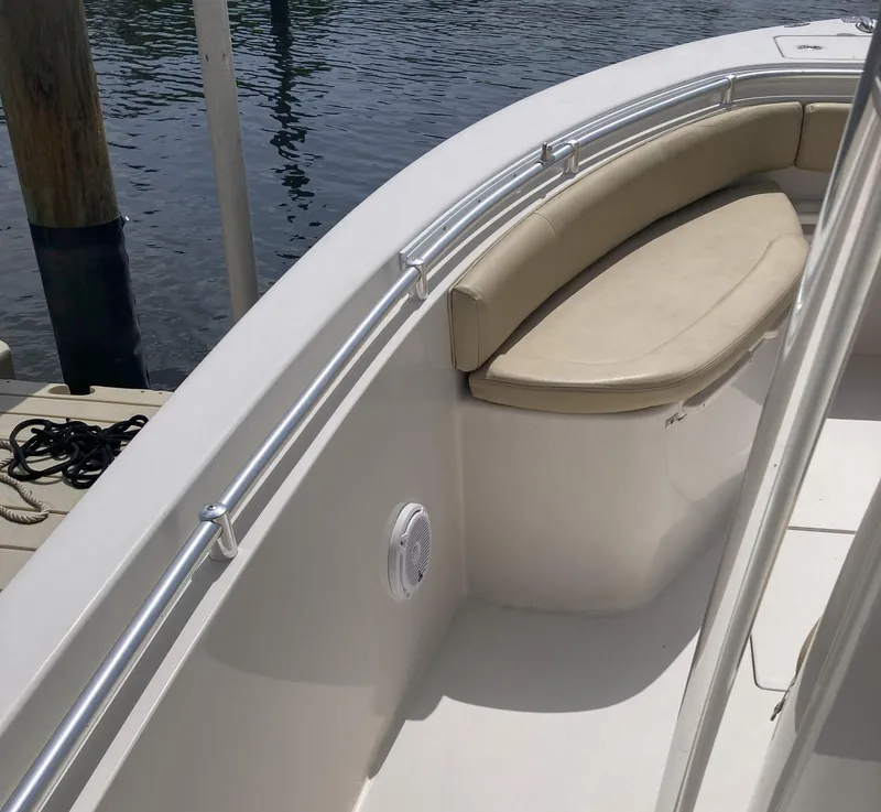 Slide: The Image of 2008 Cobia 256 Center Console boat with cushioned seating and stainless steel railings. - 13