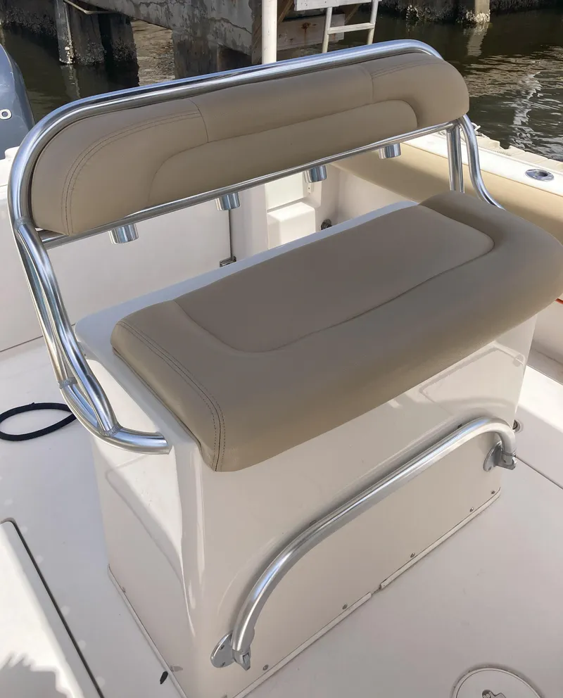 Slide: The Image of 2008 Cobia 256 Center Console boat with beige cushioned seating. - 17