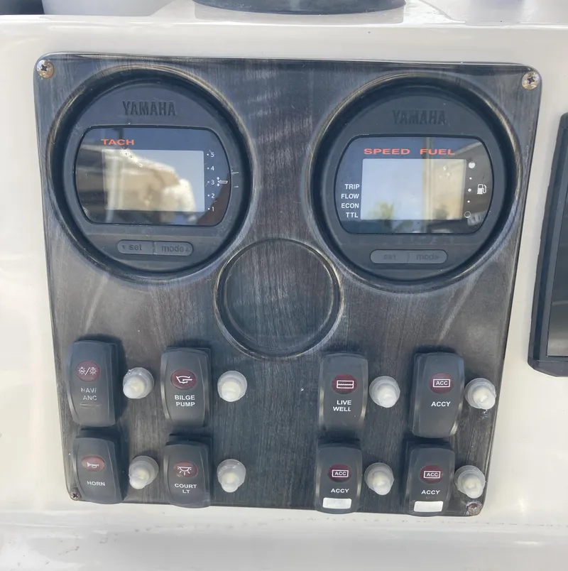 Slide: The Image of Control panel of a 2008 Cobia 256 Center Console boat with Yamaha gauges. - 24
