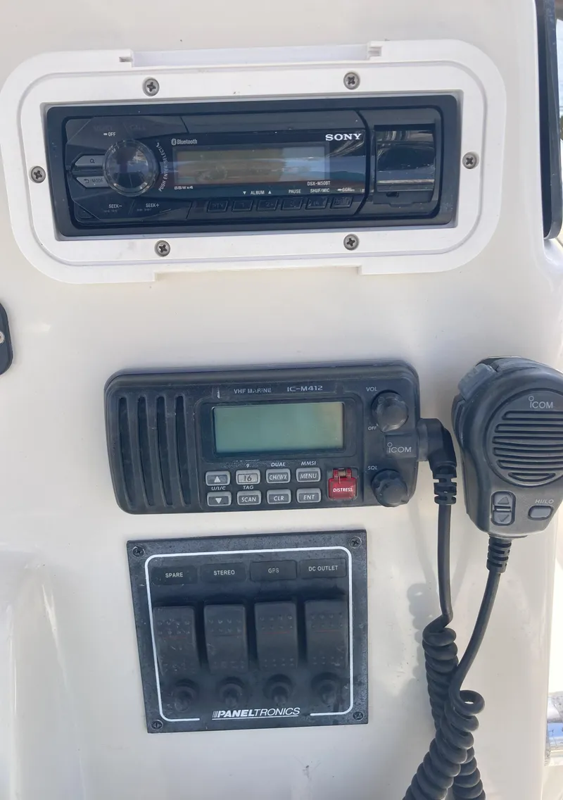 Slide: The Image of 2008 Cobia 256 Center Console boat dashboard with Sony stereo and Icom radio. - 27