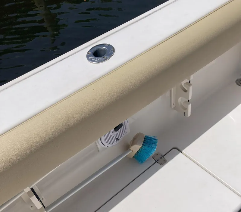 Slide: The Image of 2008 Cobia 256 Center Console boat interior with a blue brush and beige padding. - 30