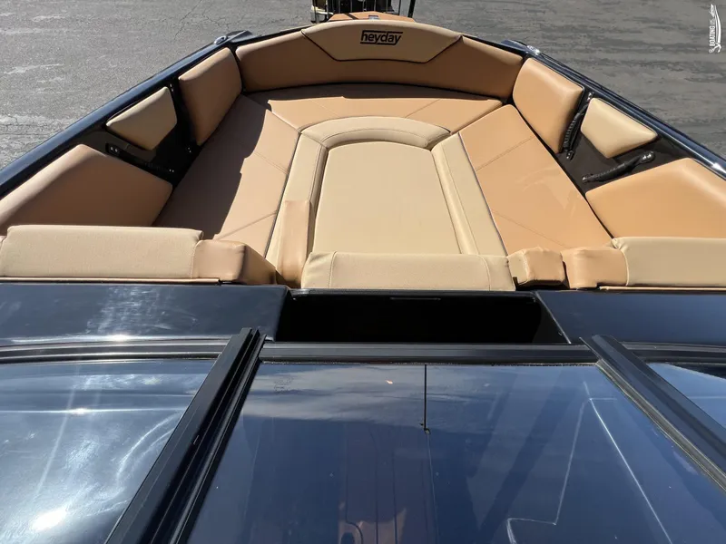 Slide: The Image of 2024 Heyday WT Surf boat with tan cushioned seating area. - 4