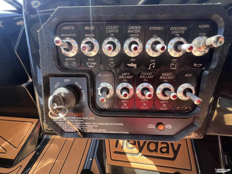 Slide: The Image of Control panel of a 2024 Heyday WT Surf boat with various switches and key ignition. - 6