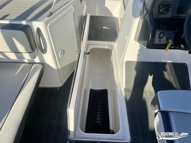 Slide: The Image of 2025 Yamaha AR190 boat interior with open storage compartment and seating area. - 4